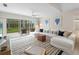 The living room has a white sectional sofa, neutral rug, and sliding doors to a screened-in patio at 7641 Quinto Dr, Sarasota, FL 34238