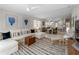 Bright and airy living room with sectional sofa, ceiling fan, and view of dining area and kitchen at 7641 Quinto Dr, Sarasota, FL 34238