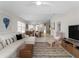 Living room with a sectional sofa, a neutral rug, a television and a view of the dining area at 7641 Quinto Dr, Sarasota, FL 34238
