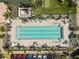 Aerial view of pool area with sun loungers, palm trees, and convenient parking at 7641 Quinto Dr, Sarasota, FL 34238