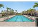 Outdoor swimming pool with lounge chairs and lush landscaping at 7641 Quinto Dr, Sarasota, FL 34238