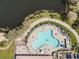 Aerial view of uniquely shaped pool area with ample seating and lush landscaping at 7641 Quinto Dr, Sarasota, FL 34238