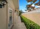 Beautiful side yard featuring a covered walkway and lush, green hedge lining the property's perimeter at 7641 Quinto Dr, Sarasota, FL 34238