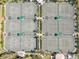 Aerial view features well-maintained tennis courts, lush landscaping, and convenient lighting at 7641 Quinto Dr, Sarasota, FL 34238