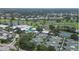 Wide aerial view showcasing community with golf course, tennis courts, and other amenities at 802 Montrose Dr # 204, Venice, FL 34293