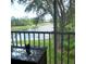 This backyard view features a serene lake surrounded by lush greenery, seen through a screened window at 802 Montrose Dr # 204, Venice, FL 34293