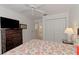 Bright bedroom with a ceiling fan, a large closet, and a lovely floral patterned bedspread at 802 Montrose Dr # 204, Venice, FL 34293