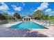 Inviting community pool surrounded by lounge chairs and lush landscaping at 802 Montrose Dr # 204, Venice, FL 34293
