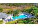 Aerial view of a pristine pool with palm trees and plenty of lounge chairs at 802 Montrose Dr # 204, Venice, FL 34293