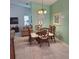 Dining room with a glass table, four chairs, neutral tones, and view to Gathering room for a warm space at 802 Montrose Dr # 204, Venice, FL 34293