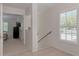 Entryway featuring tile floors, staircase, and shuttered window with natural light at 802 Montrose Dr # 204, Venice, FL 34293