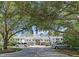 Exterior shot of the townhomes featuring mature landscaping and a well-maintained parking area at 802 Montrose Dr # 204, Venice, FL 34293