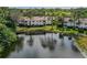 Scenic view of the condo complex overlooking a peaceful pond and lush greenery at 802 Montrose Dr # 204, Venice, FL 34293