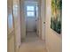 Hallway leading to the laundry room, enhanced by a vibrant tropical painting at 802 Montrose Dr # 204, Venice, FL 34293