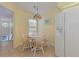 Eat-in kitchen area with a round table and chairs, white refrigerator, and a decorative light fixture at 802 Montrose Dr # 204, Venice, FL 34293