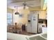 Eat-in kitchen featuring a dining table with chairs, large fridge, and plentiful counterspace by the bright window at 802 Montrose Dr # 204, Venice, FL 34293