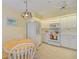 Bright kitchen featuring white appliances, cabinets and a charming light fixture over the breakfast table at 802 Montrose Dr # 204, Venice, FL 34293
