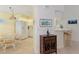 Eat-in kitchen with white appliances, a breakfast bar, and tiled floors at 802 Montrose Dr # 204, Venice, FL 34293