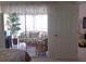 Cozy lanai with comfortable seating and serene views, accessible from the bedroom via sliding glass doors at 802 Montrose Dr # 204, Venice, FL 34293