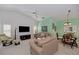 Bright and open living room featuring sofas, a TV, and a view to dining space with natural light at 802 Montrose Dr # 204, Venice, FL 34293