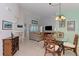 Open-concept living room and dining area with a large sectional sofa, TV, and comfortable seating arrangement at 802 Montrose Dr # 204, Venice, FL 34293