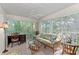Enclosed patio with comfortable seating, offering a tranquil space with natural views and sunlit ambiance at 802 Montrose Dr # 204, Venice, FL 34293