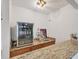 Home bar with granite counters, display shelves, and a beverage cooler at 8160 Glenbrooke Ct, Sarasota, FL 34234