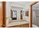 Bright bathroom with vanity with double mirrors and a shower with a shower curtain at 8160 Glenbrooke Ct, Sarasota, FL 34234