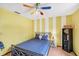 Bright bedroom featuring unique striped accent wall and colorful ceiling fan at 8160 Glenbrooke Ct, Sarasota, FL 34234