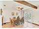 Dining room with wood table set with views to the backyard through glass doors at 8160 Glenbrooke Ct, Sarasota, FL 34234