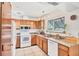Well-lit kitchen with granite countertops, wood cabinets, and stainless steel appliances at 8160 Glenbrooke Ct, Sarasota, FL 34234