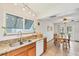 Open floor plan with kitchen featuring granite countertops and stainless steel sink at 8160 Glenbrooke Ct, Sarasota, FL 34234