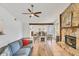 Open-concept living room featuring a stone fireplace and an adjoining dining area at 8160 Glenbrooke Ct, Sarasota, FL 34234