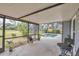 View of a screened lanai area with inground pool and landscaped yard at 8160 Glenbrooke Ct, Sarasota, FL 34234