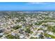 Aerial view of a residential neighborhood with homes surrounded by lush greenery near the ocean at 9366 Westminster Ave, Englewood, FL 34224