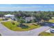 Aerial view of a well-maintained home with mature trees and landscaping in a peaceful neighborhood at 9366 Westminster Ave, Englewood, FL 34224