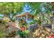 Charming screened lanai with brick patio and lush tropical landscaping at 9366 Westminster Ave, Englewood, FL 34224