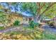 Beautiful landscaped backyard with brick patio and mature trees surrounding the property at 9366 Westminster Ave, Englewood, FL 34224