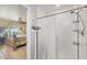Bathroom with walk-in shower, tile surround, and convenient access to the bright main bedroom at 9366 Westminster Ave, Englewood, FL 34224