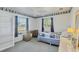Bedroom with a cheerful nautical theme, featuring natural light and neutral carpet at 9366 Westminster Ave, Englewood, FL 34224
