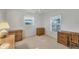 Bedroom with natural light and neutral carpet flooring featuring multiple wood dressers at 9366 Westminster Ave, Englewood, FL 34224