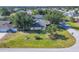 Well-maintained single-story home with a green lawn and mature landscaping at 9366 Westminster Ave, Englewood, FL 34224