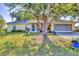 Charming single-story home with a well-manicured lawn and mature tree in a quiet residential neighborhood at 9366 Westminster Ave, Englewood, FL 34224
