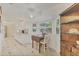Bright kitchen features a casual dining area, white cabinetry, tile floors and natural light at 9366 Westminster Ave, Englewood, FL 34224