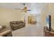 Cozy living room with tile flooring, a ceiling fan, and a dining area for comfortable living at 9366 Westminster Ave, Englewood, FL 34224