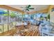 Spacious sunroom with lots of natural light, wood floors and plenty of seating at 9366 Westminster Ave, Englewood, FL 34224