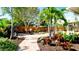 Paver path leads to a patio dining area in the tropical backyard oasis at 1010 68Th Nw St, Bradenton, FL 34209