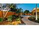 Landscaped backyard has a dining set on a stone patio surrounded by lush greenery and ambient lighting at 1010 68Th Nw St, Bradenton, FL 34209