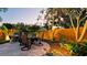 Outdoor dining set on stone patio perfect for enjoying meals in a beautifully landscaped backyard at 1010 68Th Nw St, Bradenton, FL 34209