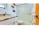 Bathroom features a marble countertop sink, shower, and playful fish wall decor at 1010 68Th Nw St, Bradenton, FL 34209
